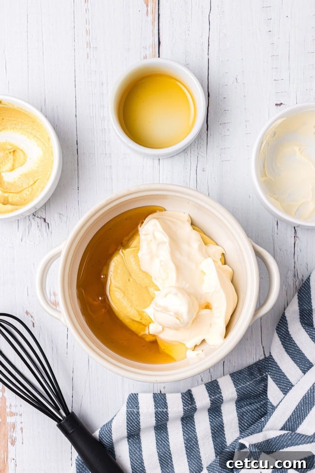 Step 7: Whisking mayonnaise, Dijon mustard, and honey in a bowl to make the dipping sauce.