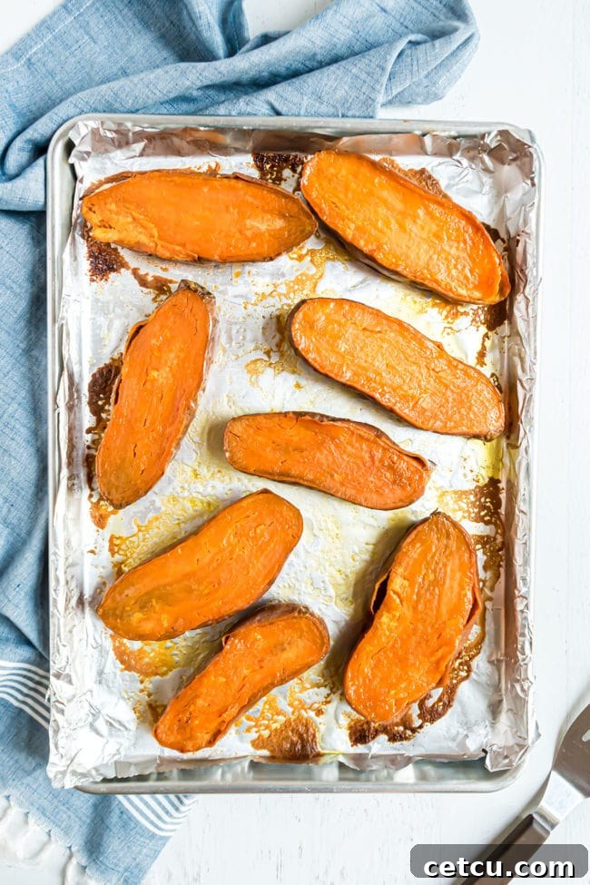 halved sweet potatoes on a baking sheet flesh side up
