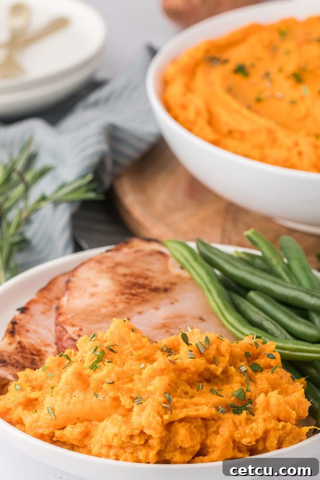 mashed sweet potatoes with green beans and ham with parsley garnish
