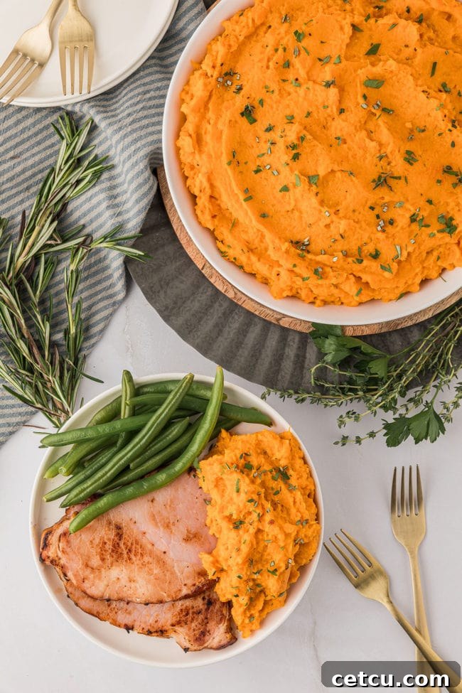 overhead shot of mashed sweet potatoes with green beans and ham