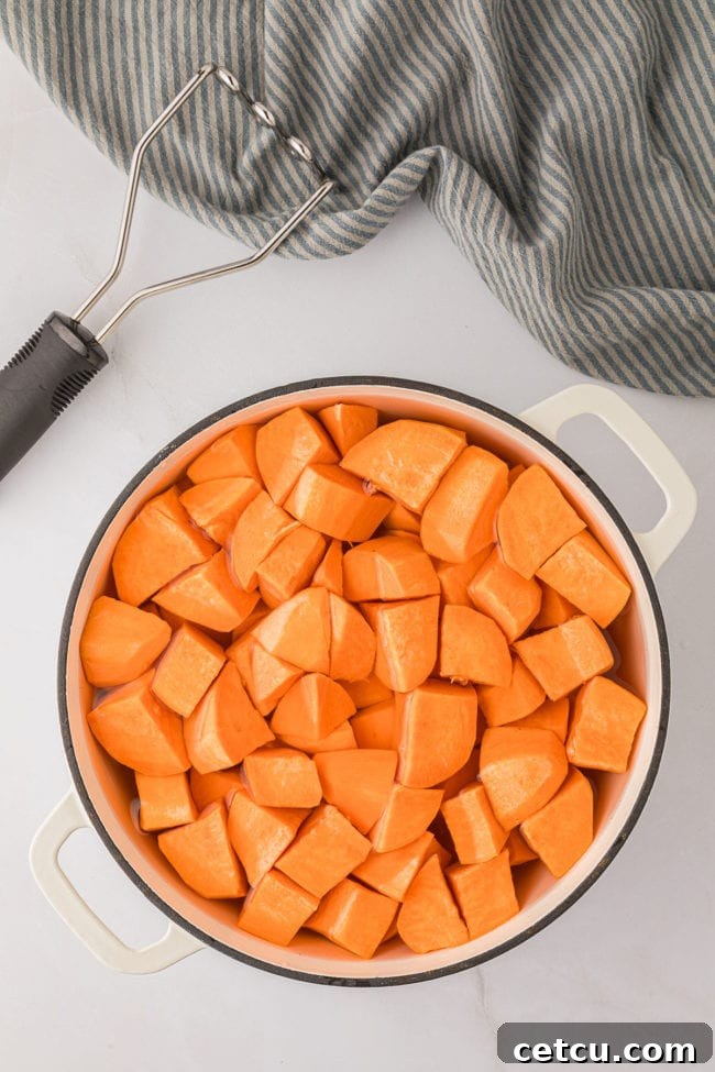 white pot with cubed sweet potatoes