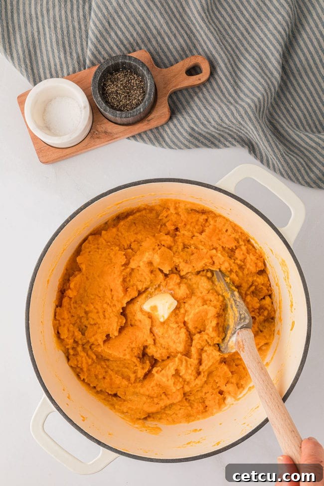 stirring mashed sweet potatoes in a warm pot