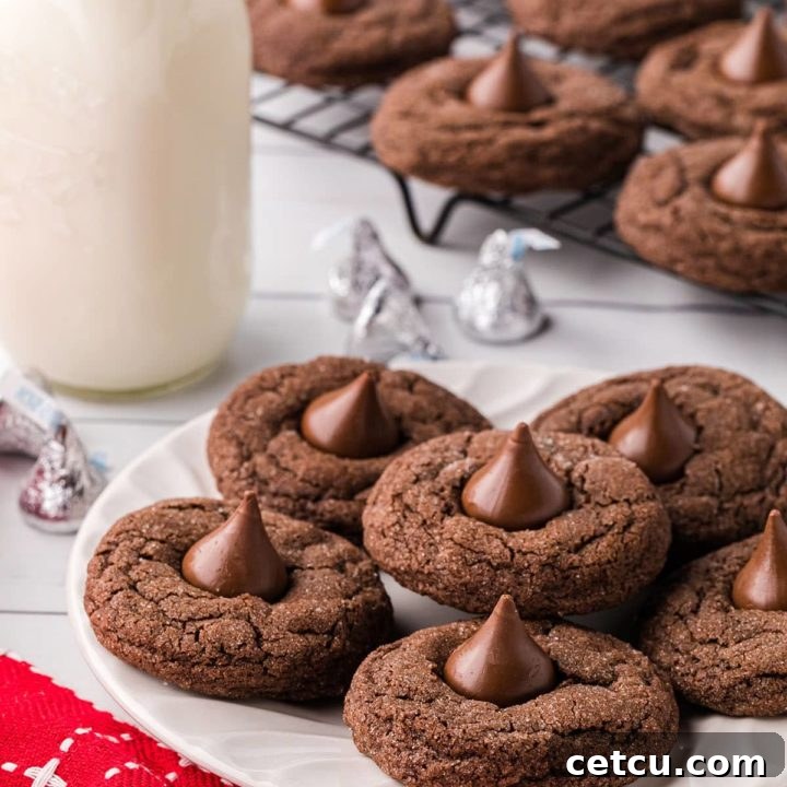 chocolate kiss cookies on a plate and cooling rack with a bottle of milk