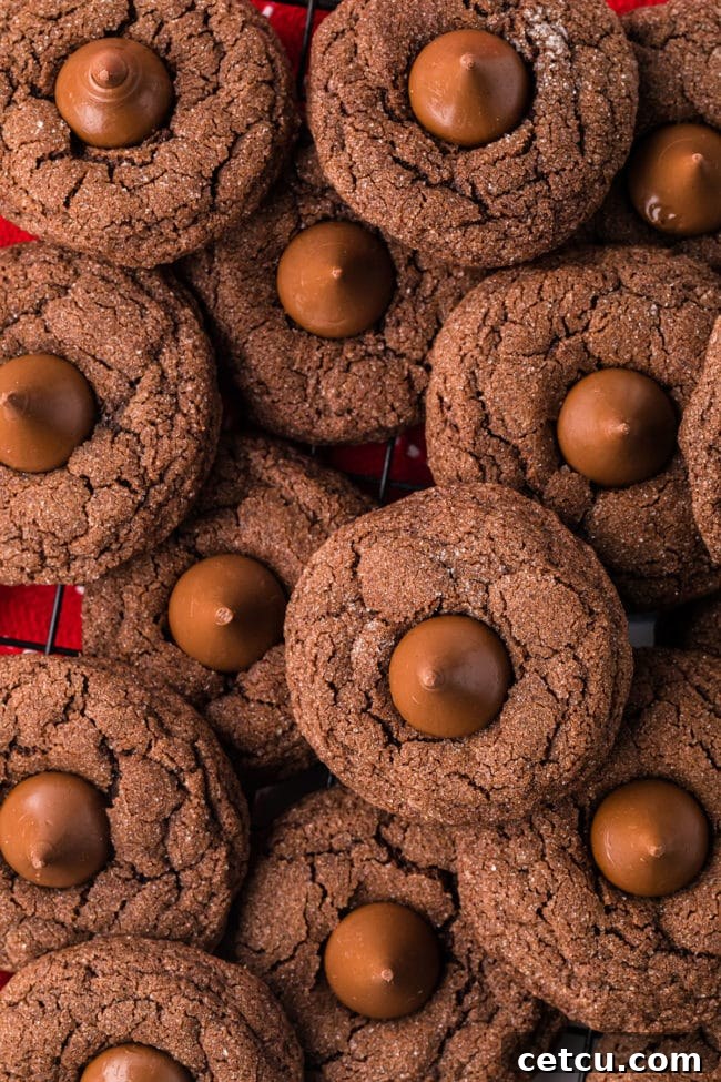 A generous pile of freshly baked Double Chocolate Kiss Cookies, showcasing their rich color and the perfectly melted chocolate kisses on top.