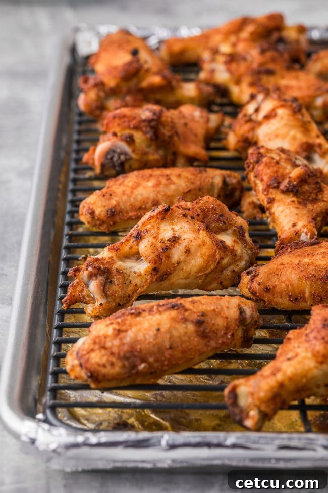 A close-up shot of perfectly crispy baked party wings, golden brown and ready to be sauced or served as is.