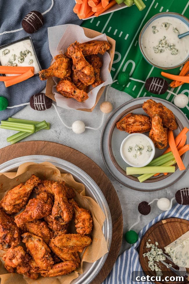 A bowl overflowing with crispy oven baked chicken wings, perfectly cooked and ready for a game day celebration.