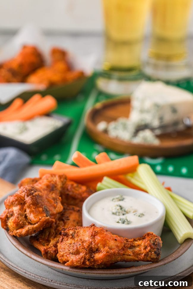 A vibrant game day spread featuring crispy baked chicken wings alongside a variety of dips and snacks, perfect for entertaining.