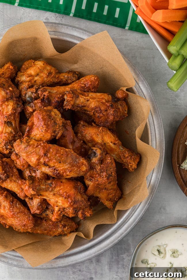 A generous serving of crispy baked party wings, freshly sauced and presented in a large bowl, ready for serving.