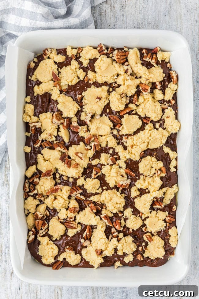 Step 8: Spreading the top cookie layer and sprinkling with nuts