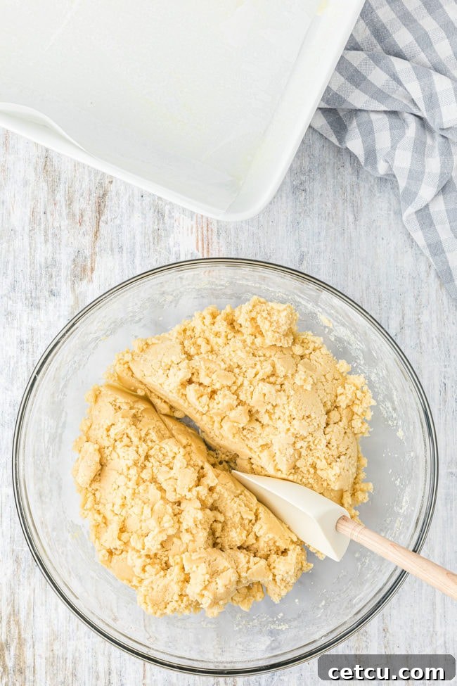 Step 5: Pressing half of the cookie mixture into the prepared pan