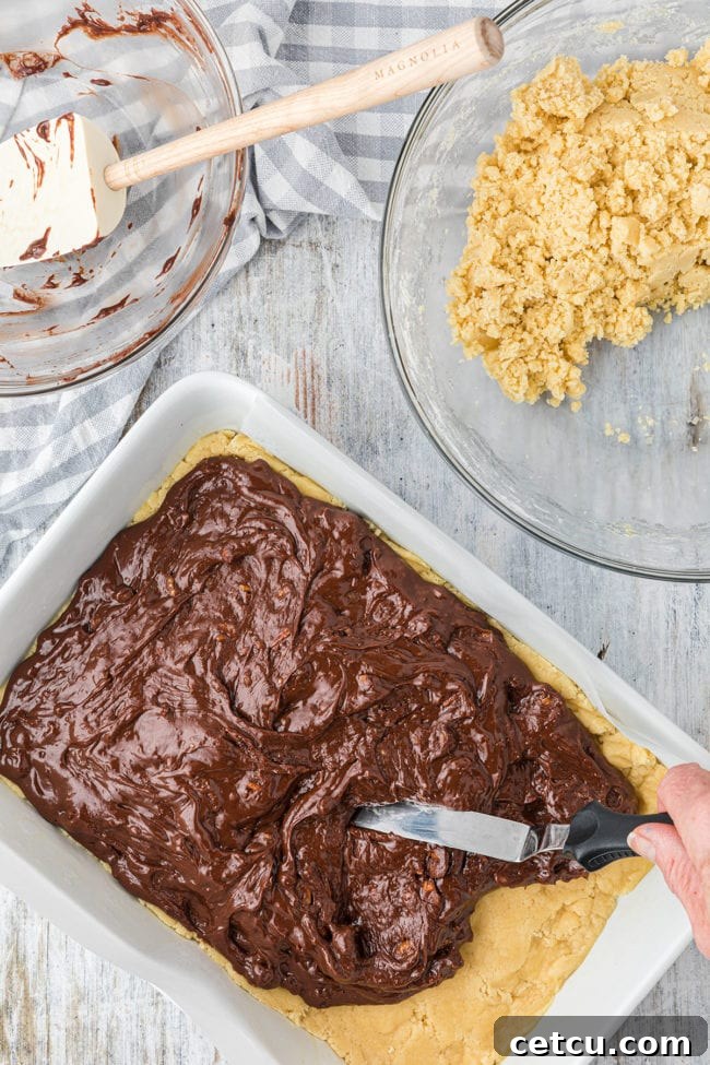 Step 7: Dolloping the remaining cookie mixture over the fudge layer