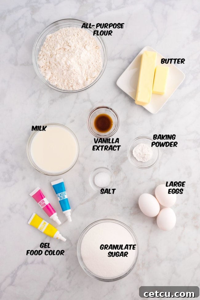 A collection of ingredients laid out on a surface, including flour, sugar, butter, eggs, milk, vanilla, and various pastel food colorings, ready for baking Spring cupcakes.