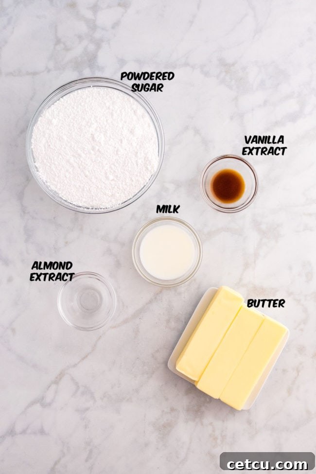 Ingredients for buttercream frosting, including softened butter, powdered sugar, vanilla extract, and milk, arranged on a kitchen counter.