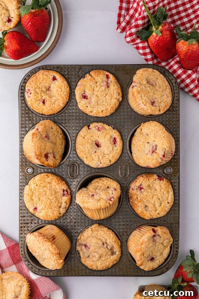 strawberry muffins in a muffin pan.