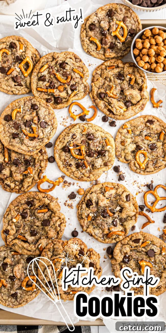 A tantalizing pile of freshly baked Kitchen Sink Cookies, golden-brown and overflowing with delicious mix-ins.
