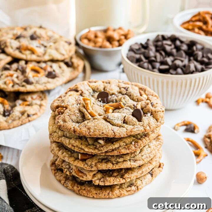 A stack of golden-brown Kitchen Sink Cookies, perfectly baked and showcasing their delightful mix-ins.