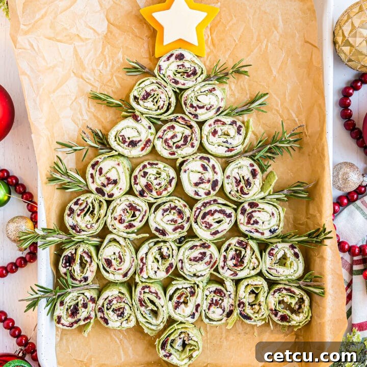 Christmas Tree pinwheel appetizers on a white pan with holiday decor