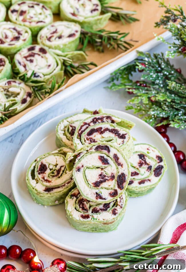 Cranberry Swirl Christmas Tree Bites 8 sliced cranberry feta pinwheels on a plate