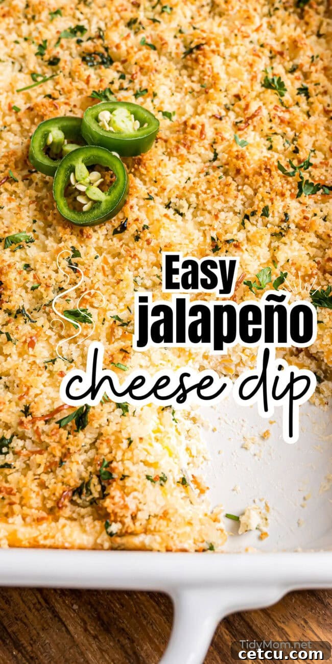 A large, golden-brown baked jalapeño popper dip, bubbling hot in a white baking dish, ready to be served, highlighting its irresistible texture.