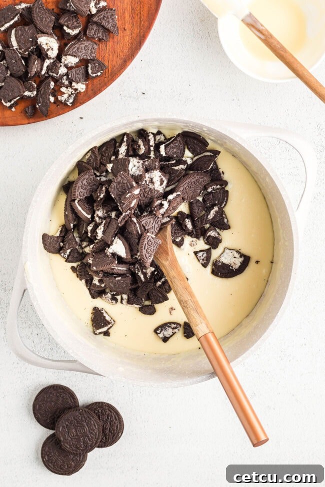 Oreo fudge step 2: Melting vanilla bark and condensed milk in a saucepan