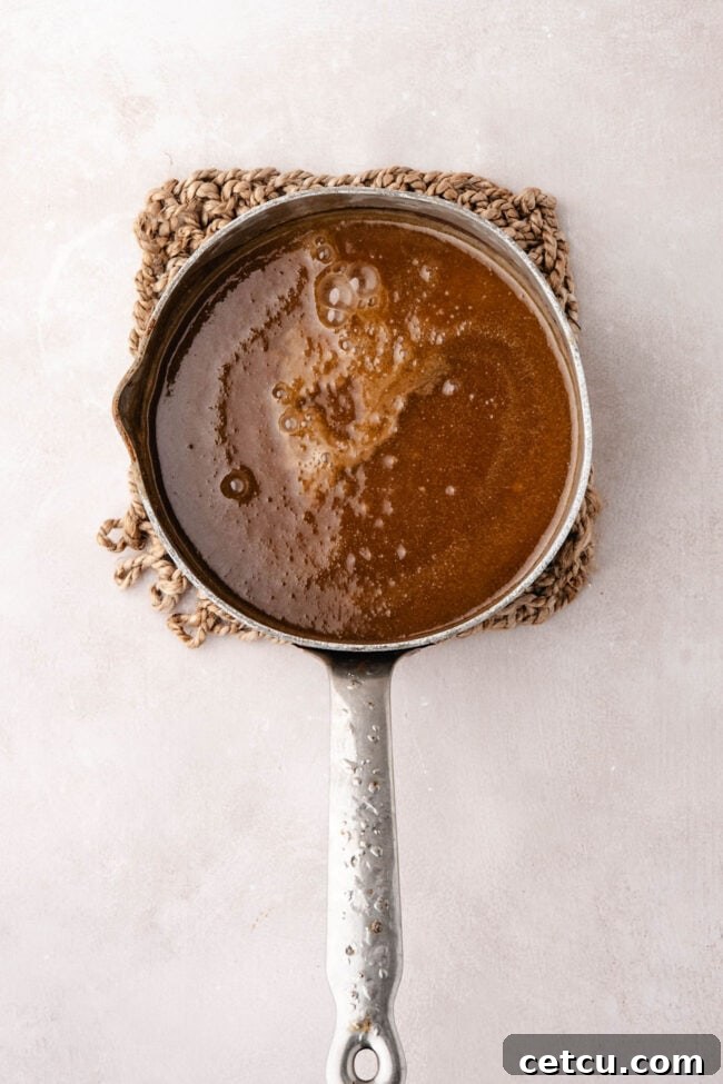 Apple cider caramel sauce in a saucepan.